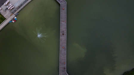 Aerial View or Drone Shot. Bridge in the middle of a green lake