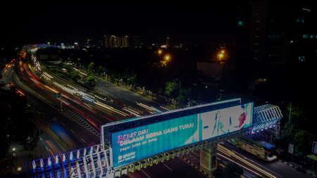 BEKASI. INDONESIA - FEBRUARY 23 2020: Aerial View. Light trails on motorway highway at night, long exposure abstract urban background at Bekasiのeditorial素材