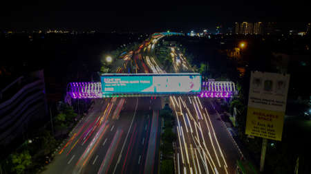 BEKASI. INDONESIA - FEBRUARY 23 2020: Aerial View. Light trails on motorway highway at night, long exposure abstract urban background at Bekasiのeditorial素材