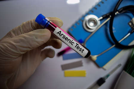 Arsenic Test text with blood sample. Top view isolated on office desk. Healthcare/Medical conceptの写真素材