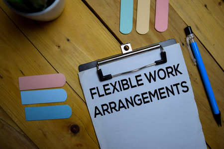 Flexible Work Arrangements write on a paperwork isolated on wooden background.の写真素材
