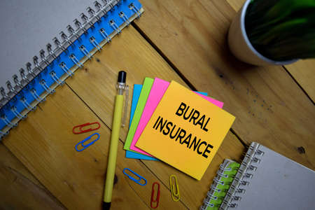 Bural Insurance write on a sticky note isolated on wooden background.