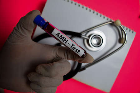 AMH - Test with blood sample. Top view isolated on office desk. Healthcare/Medical concept