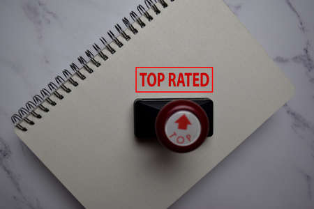 Close up Red Handle Rubber Stamper and text Top Rated isolated on White Background.の写真素材