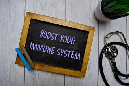 Boost Your Immune System write on a chalkboard isolated on office desk.の写真素材