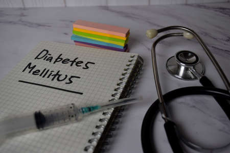 Diabetes Mellitus write on a book and keyword isolated on Office Desk. Healthcare/Medical Conceptの写真素材