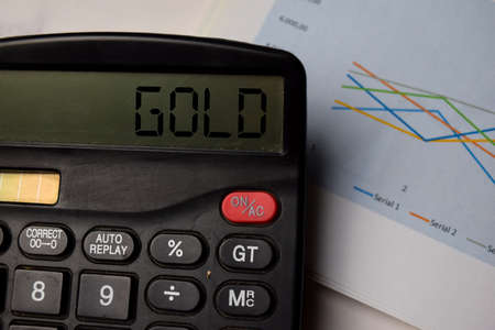 Gold write on the calculator on Office Desk.の写真素材