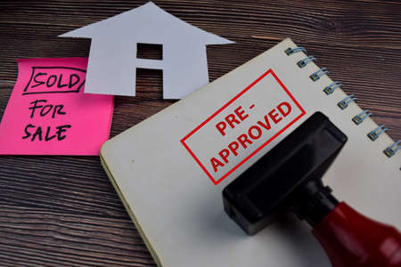House For Sale write on a book and Red Handle Rubber Stamper Pre-Approved text isolated on the...
