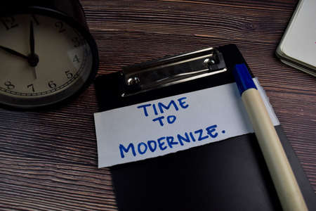 Time To Modernize write on sticky notes isolated on the table.