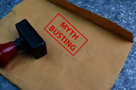 Myth Busting text on document above brown isolated on Office Deskの写真素材