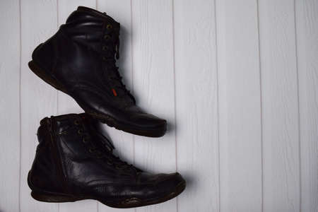 pair of old leather boots on wooden floor. Vintage style conceptの写真素材