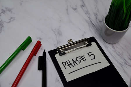 Phase 5 write on clipboard isolated on office deskの写真素材
