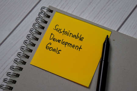 Sustainable Development Goals write on a book isolated on office deskの写真素材