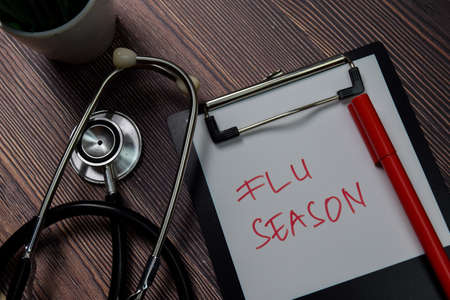 Flu Season write on paperwork isolated on wooden table.の写真素材