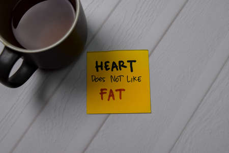 Heart Does Not Like Fat write on sticky note isolated on wooden table.の写真素材