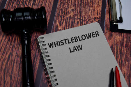 Book about Whistleblower Law isolated on wooden table.の写真素材