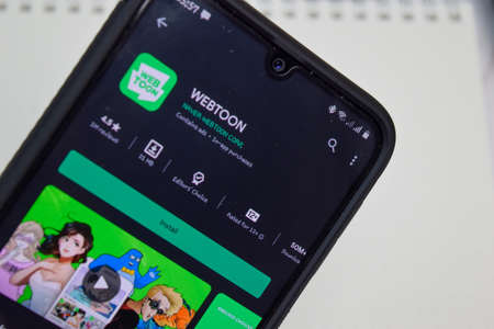 BEKASI, WEST JAVA, INDONESIA. JUNE 12, 2020 : WEBTOON dev app with magnifying on Smartphone screen....