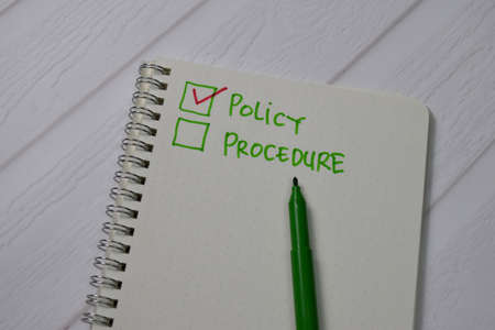 Policy and Procedure write on a book. Supported by an additional services isolated wooden table.の写真素材