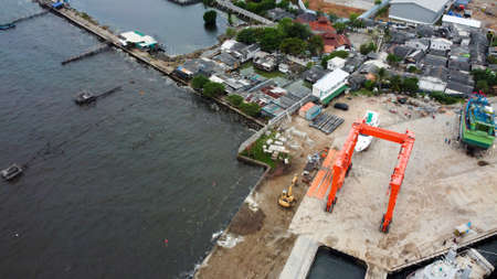 Aerial view over the marunda harbor, downtown Jakarta, Indonesia with development buildings, transportation. Jakarta, Indonesia July 3 2020のeditorial素材