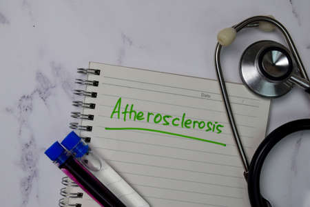 Atherosclerosis write on a book isolated wooden table.