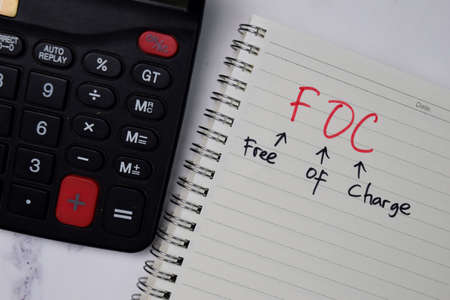 FOC - Free Of Charge write on a book isolated wooden table.の写真素材