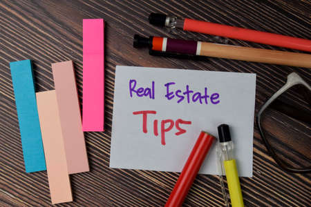 Real Estate Tips text write on sticky notes isolated on office desk.