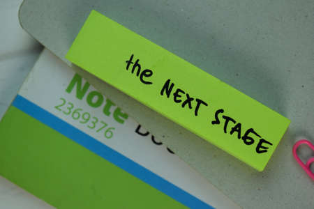 Under Promise and Over Deliver write on sticky note isolated on Wooden Table.の写真素材