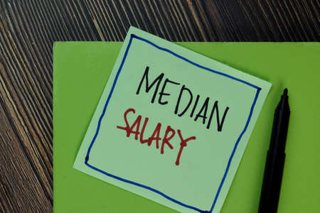 Equal Pay write on sticky notes isolated on Wooden Table.の写真素材