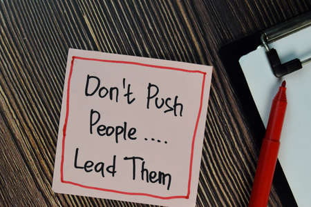 Equal Pay write on sticky notes isolated on Wooden Table.の写真素材