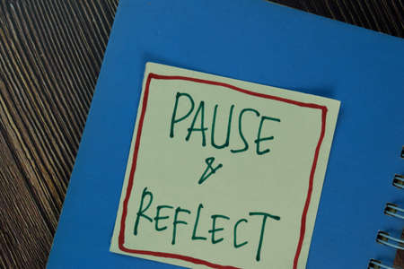 Equal Pay write on sticky notes isolated on Wooden Table.の写真素材