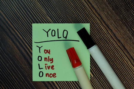 One Life Live It write on sticky notes isolated on Wooden Table.