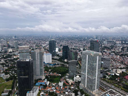 Aerial view of BNI Life building in Jakarta and noise cloud with cityscape. BNI Life is the best insurance in Jakarta. JAKARTA - Indonesia. February 4, 2021のeditorial素材