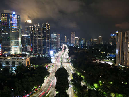Spectacular nighttime skyline of a big modern city at night. Semanggi, Jakarta, Indonesia. Aerial...