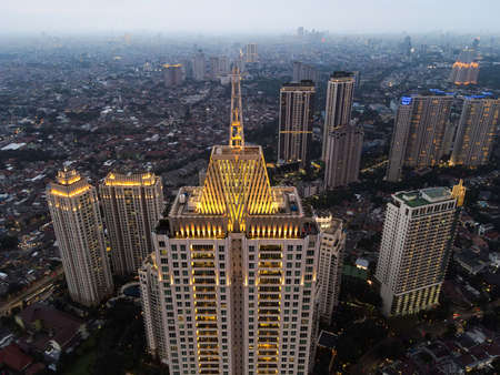 Pakubuwono skyline aerial drone view from above, Jakarta downtown skyscrapers cityscape and noise cloud with Jakarta cityscape. JAKARTA - Indonesia. February 23, 2021のeditorial素材