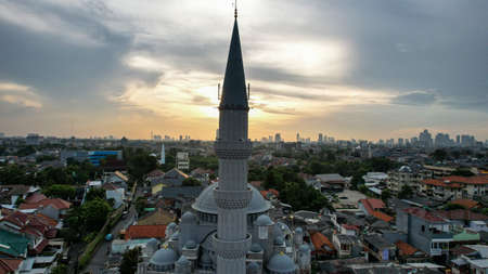 Aerial view of the largest Mosque in Jakarta. Ramadan and Eid Concept and noise cloud when sunset or sunrise view. Jakarta, Indonesia, May 4, 2021のeditorial素材