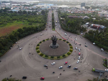 Aerial top down of traffic in Bekasi roundabout during sunny day. Cars passing road. Bekasi. Indonesia. May, 6 2021のeditorial素材