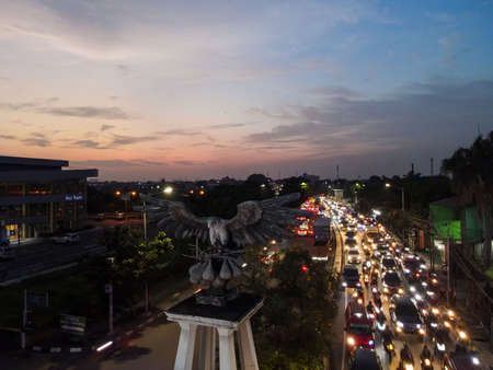 Aerial top down of traffic in Bekasi roundabout during sunny day. Cars passing road. Bekasi. Indonesia. May, 6 2021のeditorial素材