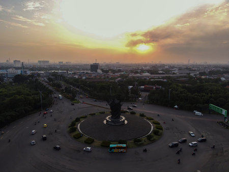 Aerial top down of traffic in Bekasi roundabout during sunny day. Cars passing road. Bekasi. Indonesia. May, 6 2021のeditorial素材