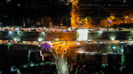 Traffic jam on the polluted streets of Bekasi at night. The traffic congestion is limited in few areas, selective focus on the road. Bekasi, Indonesia, May 8, 2021のeditorial素材