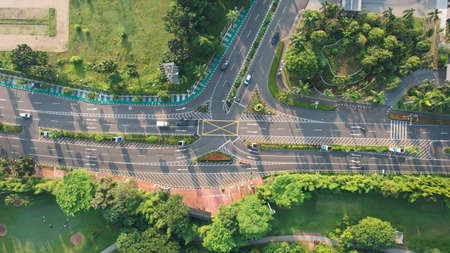 Aerial view of highway intersection and buildings in the city of Jakarta and noise cloud with...