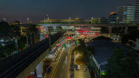 Aerial view of articulated city buses arriving and leaving at bus station near main railway station MRT line at Kebayoran Baru. Jakarta, Indonesia, July 29, 2021のeditorial素材