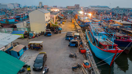 Aerial drone view of wooden boats leaning beside the pier. With noise cloud. Jakarta, Indonesia, August 3, 2021のeditorial素材