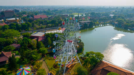 Aerial view of Ferris wheel which is located on the Taman legenda at a Taman Mini Indonesia Indah with noise cloud. Jakarta, Indonesia, August 9, 2021のeditorial素材