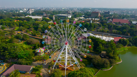 Aerial view of Ferris wheel which is located on the Taman legenda at a Taman Mini Indonesia Indah with noise cloud. Jakarta, Indonesia, August 9, 2021のeditorial素材