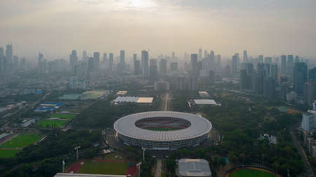 Aerial top view of the Beautiful scenery of Senayan Stadium. with Jakarta cityscape background....