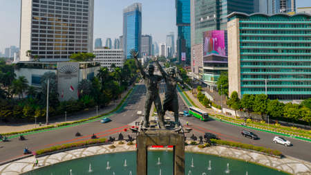 Aerial view of West Irian Liberation monument in downtown Jakarta with Jakarta cityscape. Jakarta, Indonesia, September 5, 2021のeditorial素材