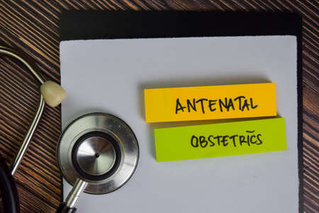 Molar Pregnancy write on sticky notes isolated on Wooden Table.の写真素材