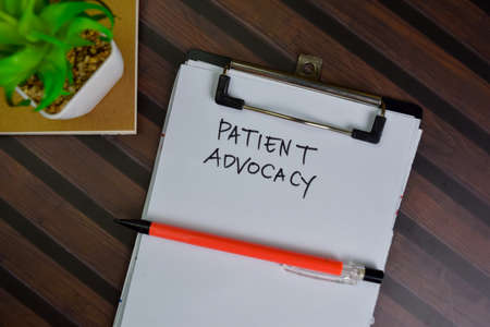 Stock and Buyback write on sticky notes isolated on Wooden Table.の写真素材