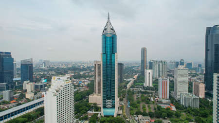 Aerial view of BNI 46 building in Jakarta and noise cloud with cityscape. BNI 46 is the best banking in Jakarta. JAKARTA - Indonesia. January 2, 2022のeditorial素材