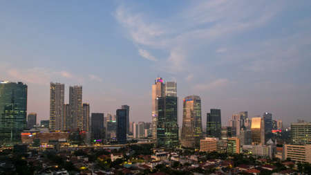 Aerial view of office buildings in Jakarta central business district and noise cloud when sunset. JAKARTA, INDONESIA - APRIL 21, 2022のeditorial素材